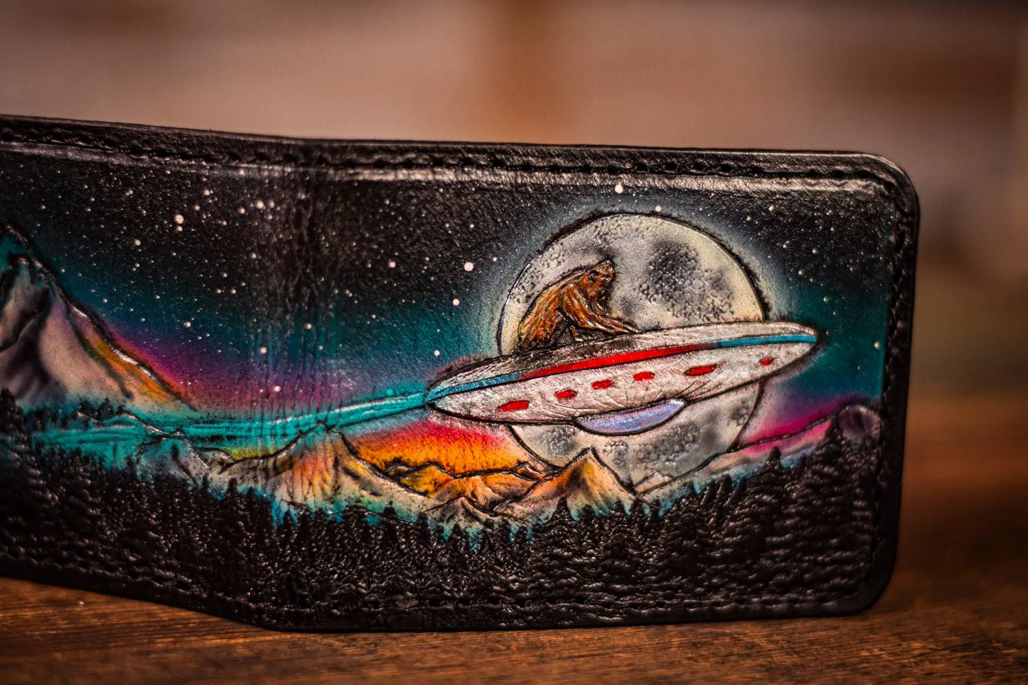 Handcrafted Leather Bifold Wallet - Bigfoot on UFO with Moonlit Mountains and Aurora Borealis - Cryptid and UFO-Inspired Wallet
