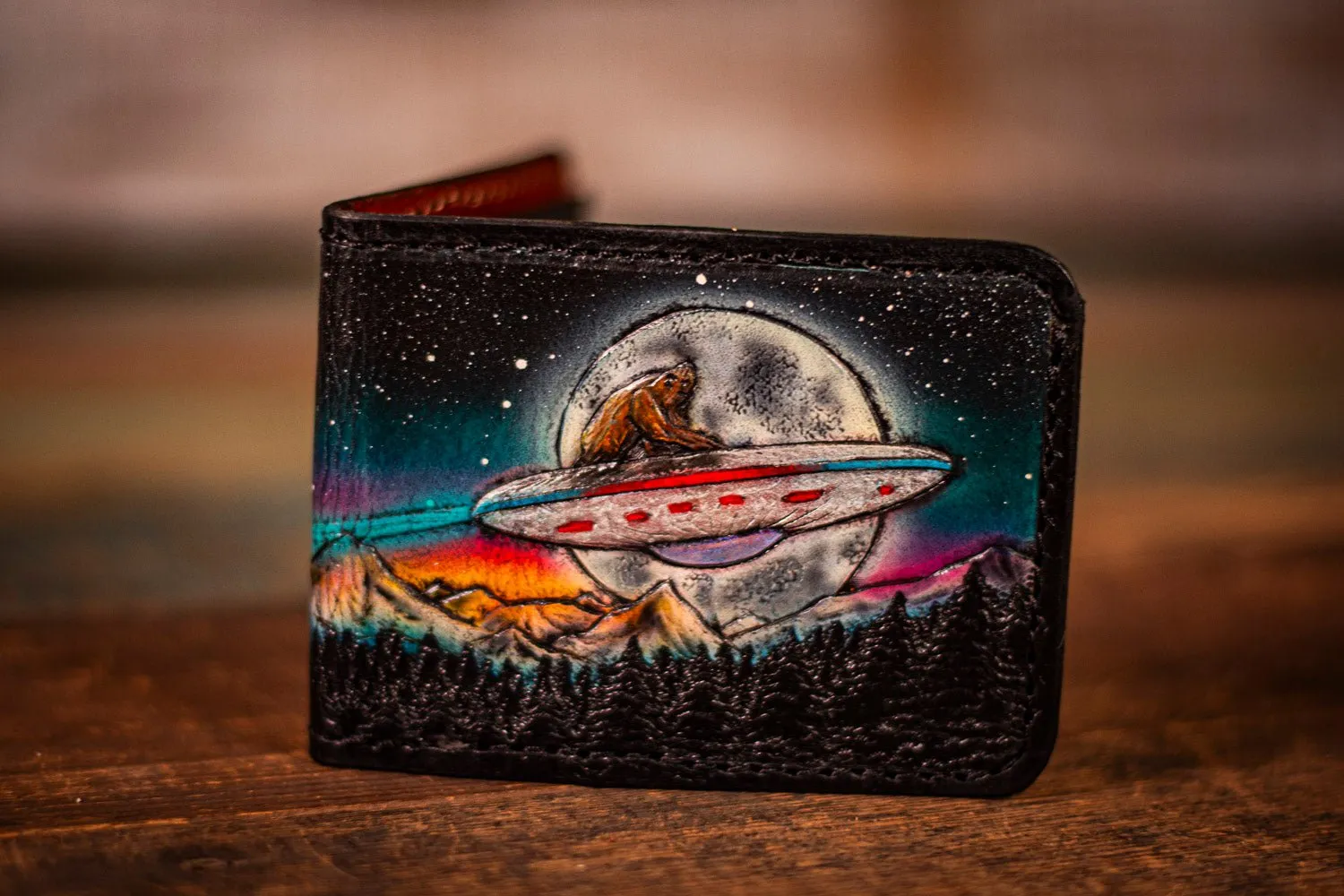 Handcrafted Leather Bifold Wallet - Bigfoot on UFO with Moonlit Mountains and Aurora Borealis - Cryptid and UFO-Inspired Wallet